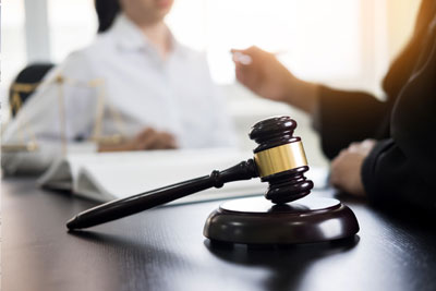 immigration-removal-defense-v2 image of gavel in front of woman