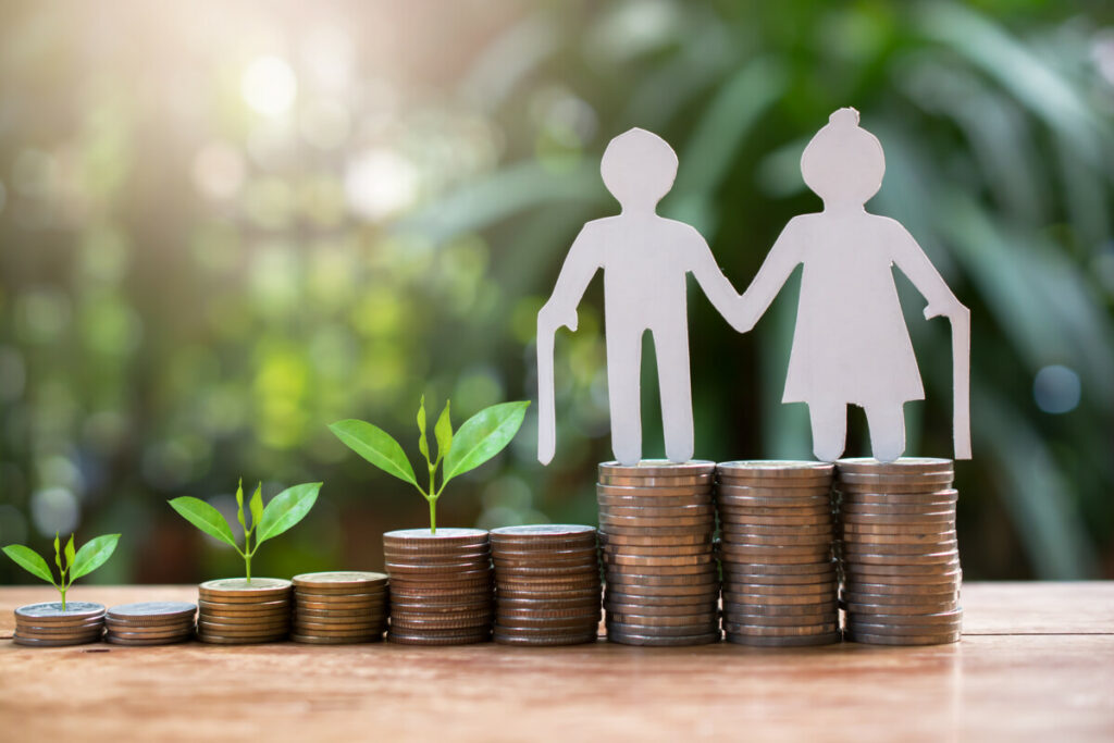 couple standing on stack of coins