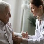 Older man with nurse or doctor