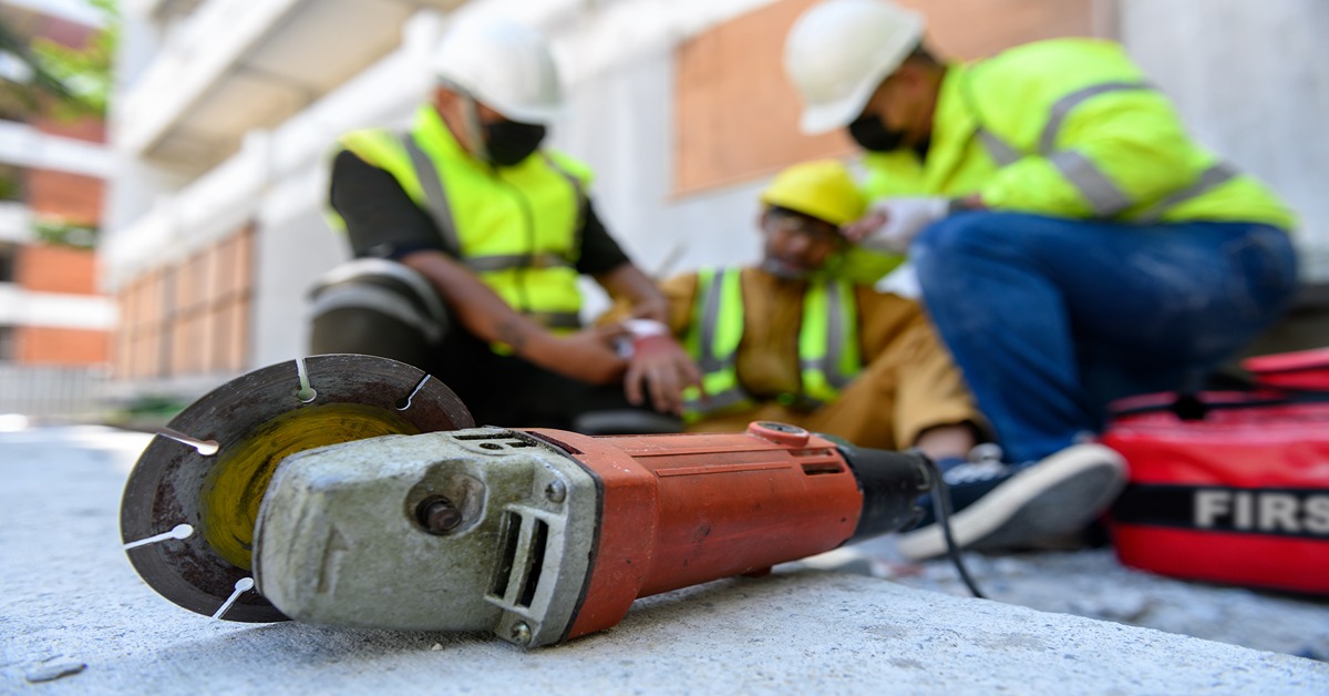 construction workers with equipment in foreground