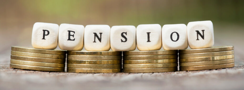 The letters PENSION on top of small stacks of coins