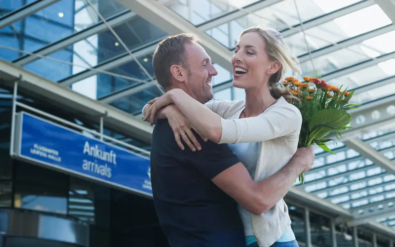 image of couple reuniting at airport with their fiance visas