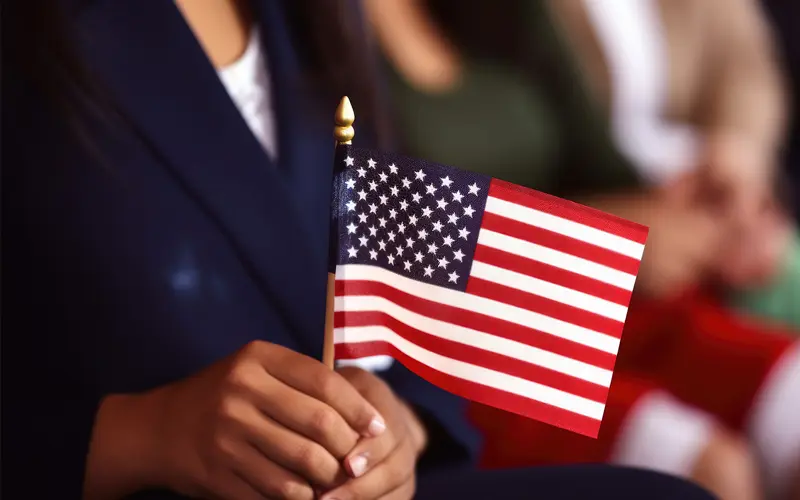 image of a woman holding american flag at ceremony