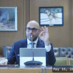 video overlay image of aaron siri testifying at the new hampshire house committee