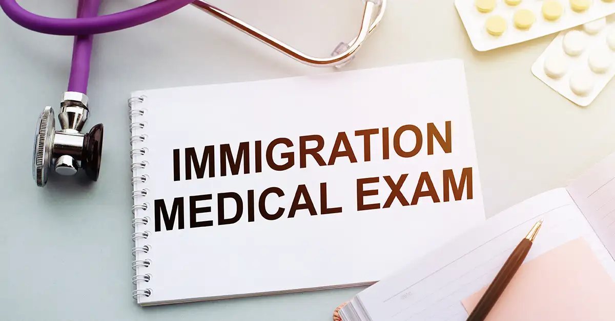 image of notebook with immigration medical exam and stethoscope