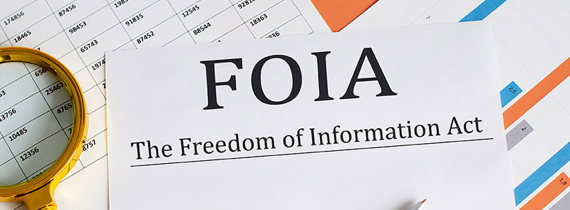 image of documents and a magnifying glass with FOIA written on them