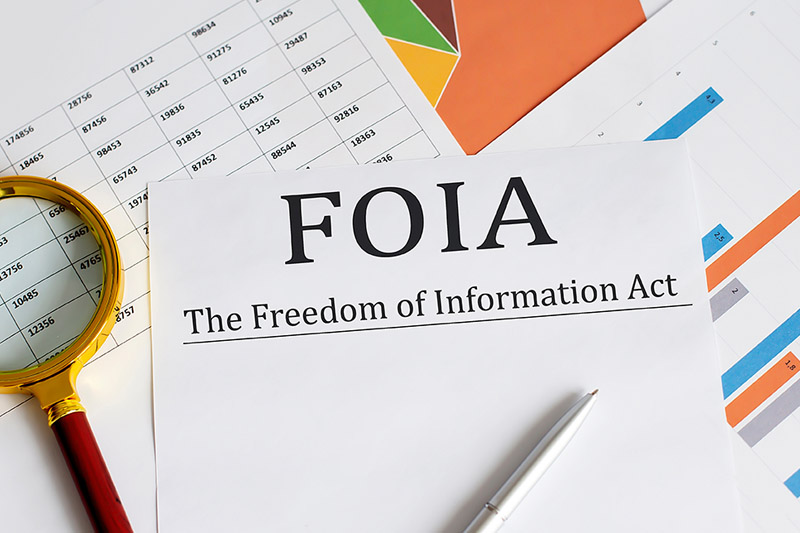 image of documents and a magnifying glass with FOIA written on them