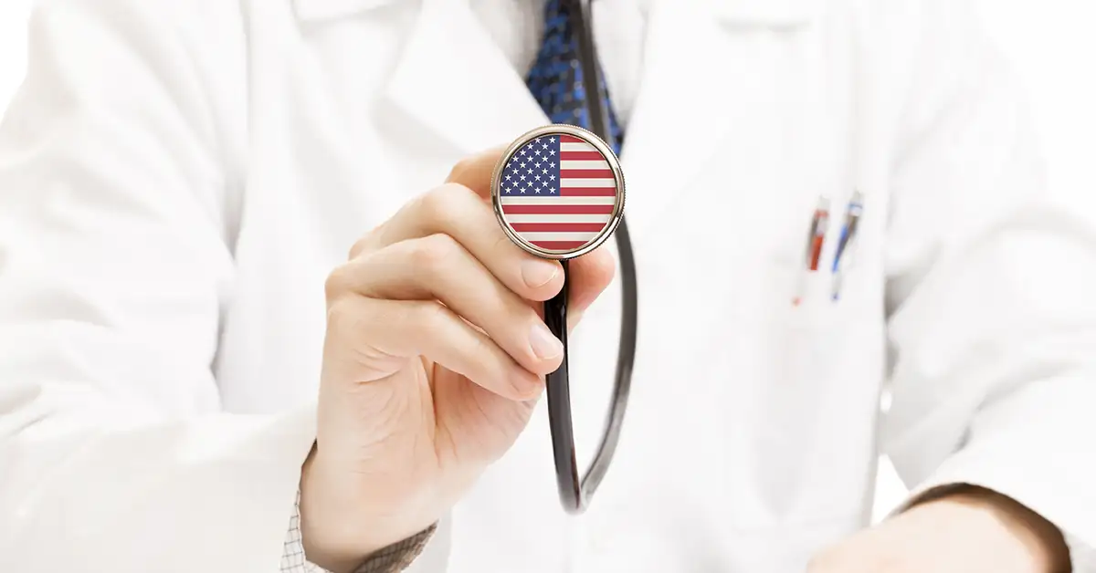 image of doctor holding stethoscope with american flag representing form I-693 immigration medical exam