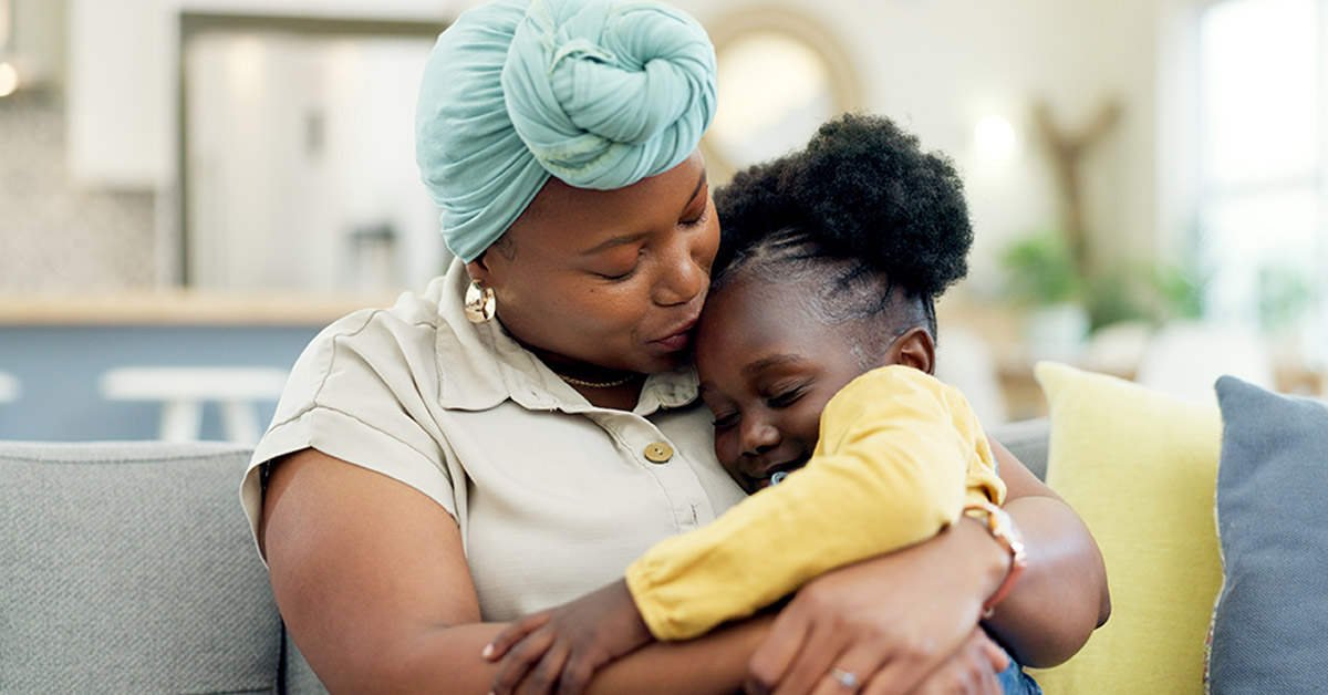 image of african-american mother holding her daughter in her arms