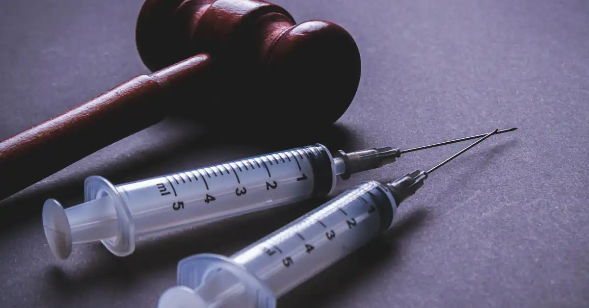image of a gavel and syringes representing vaccine injury court