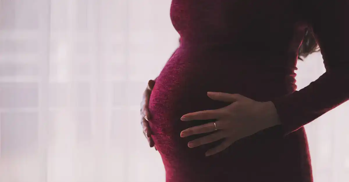 image of a pregnant woman holding her belly representing birth injury