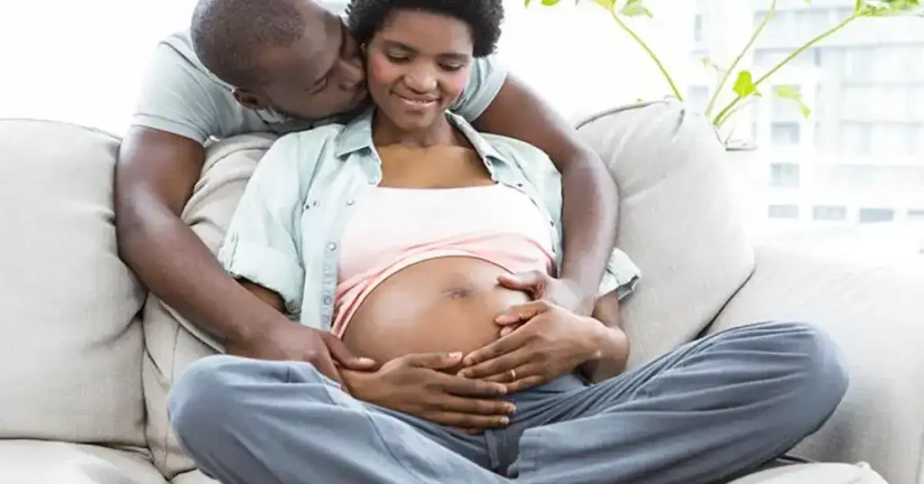 image of a pregnant african-american woman on couch