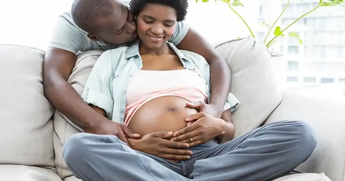 image of a pregnant african-american woman on couch