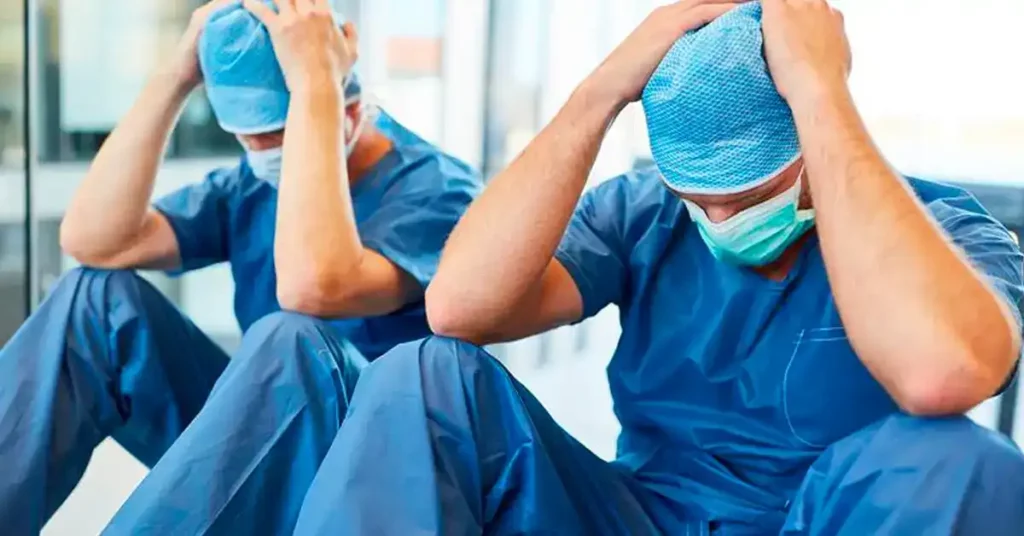image of surgeons with hands over head in disgust