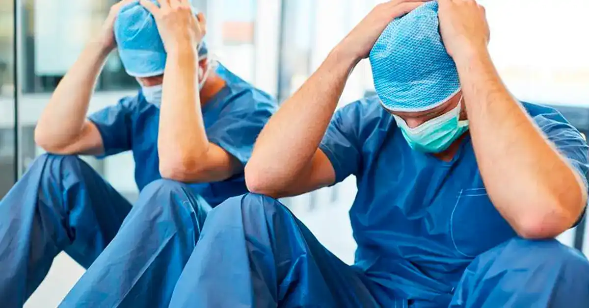 image of surgeons with hands over head in disgust