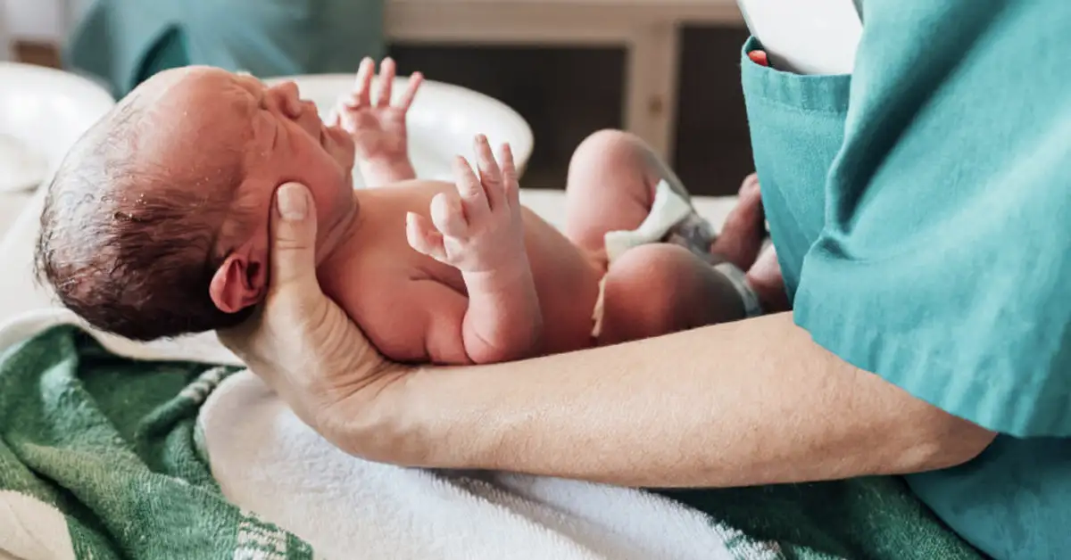 lp-doctor-holding-newborn image of a doctor holding a newborn baby