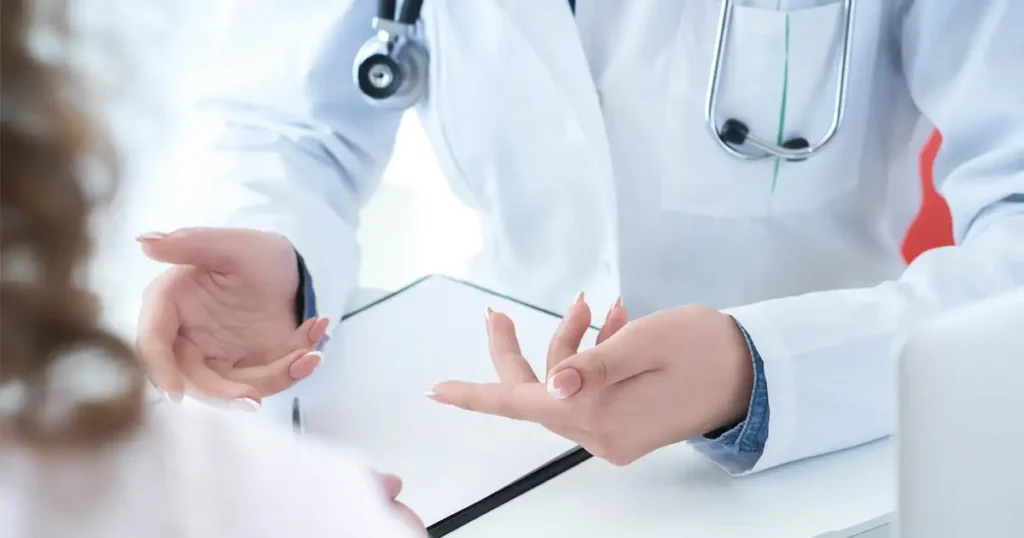 A doctor and a patient are engaged in a medical consultation, discussing the patient's symptoms related to the flu and potential adverse reactions to the flu vaccine. The doctor is likely providing information on flu vaccination and addressing any concerns about vaccine injury claims and compensation options.