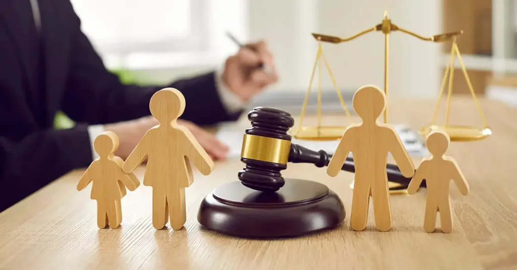 Court gavel with wooden figures of parents and children symbolizing families navigating U.S. immigration law, vaccine waiver cases, and child immigration exemptions