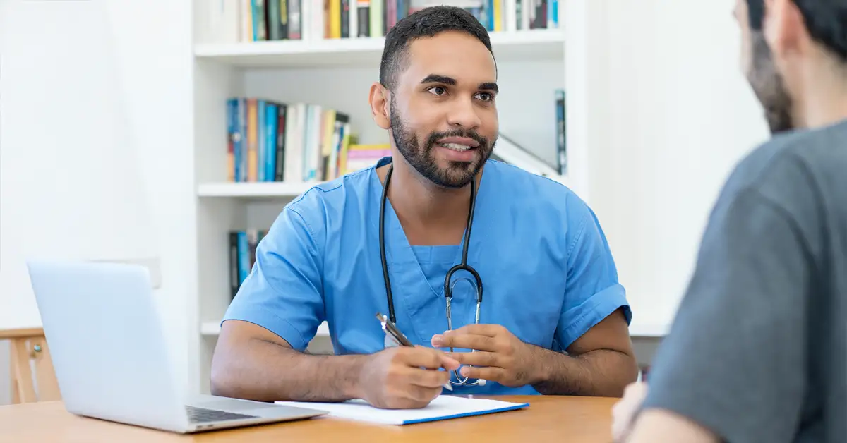 blog-dr-nurse Immigration Vaccine Waiver Civil Surgeon consulting with patient at desk.