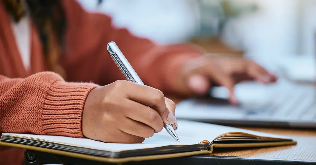 blog-student-writing Person documenting their vaccine injury case as proof in a notebook.