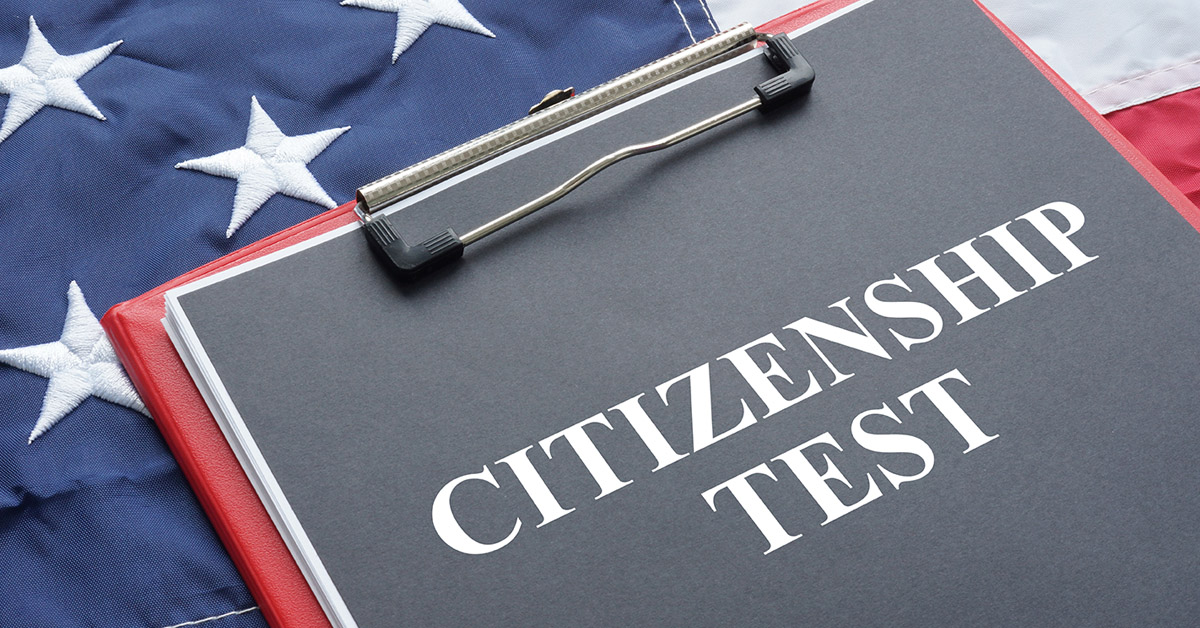 blog-citizenship-test Clipboard labeled “Citizenship Test” against an American flag, reflecting the naturalization process supported by immigration attorneys.