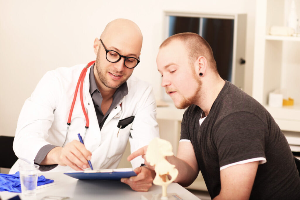 A healthcare provider in a white coat is consulting with a patient while reviewing detailed medical records, discussing potential vaccine-related injuries and vaccine injury claims. The setting reflects a professional medical environment focused on patient care and informed decision-making regarding vaccination.