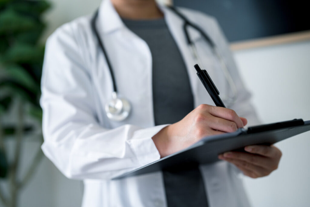 A medical professional, likely a board-certified pediatrician or infectious disease specialist, is intently reviewing detailed patient files and vaccination records, focusing on vaccine injury cases and medical evidence for potential vaccine injury claims. The setting suggests a thorough examination of vaccination records to provide expert witness testimony in legal proceedings related to vaccine-related injuries.
