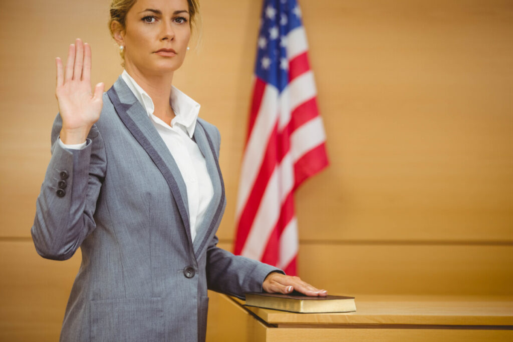 The image depicts a courtroom scene where a pediatrician is providing expert witness testimony at the witness stand, discussing vaccine injury claims and related medical records. The atmosphere is serious, reflecting the legal proceedings surrounding vaccine-related injuries and compensation.
