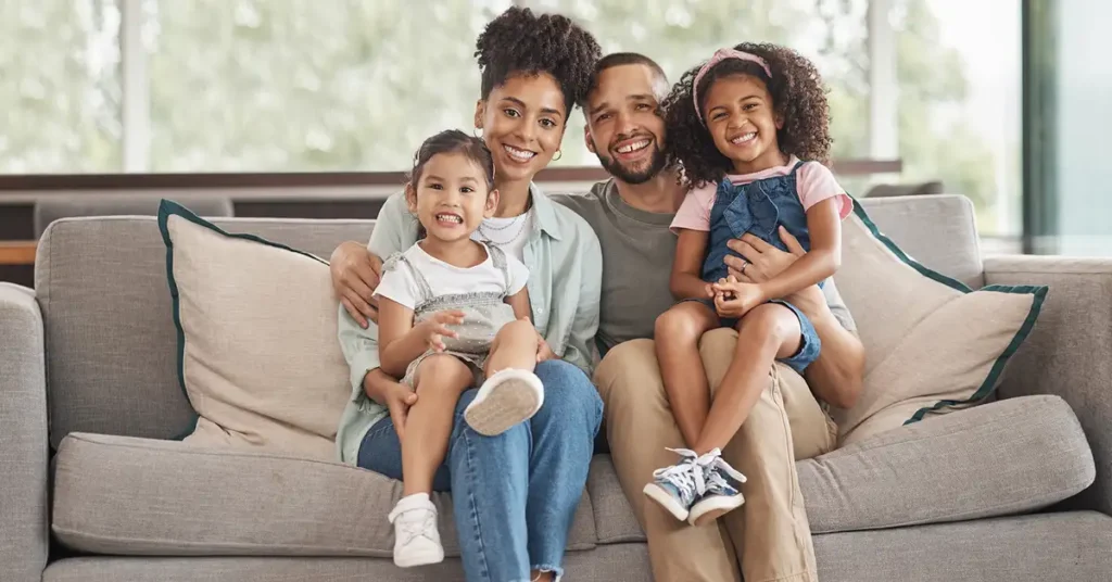 A family sitting together on a couch, representing family-based immigration matters assisted by immigration attorneys.