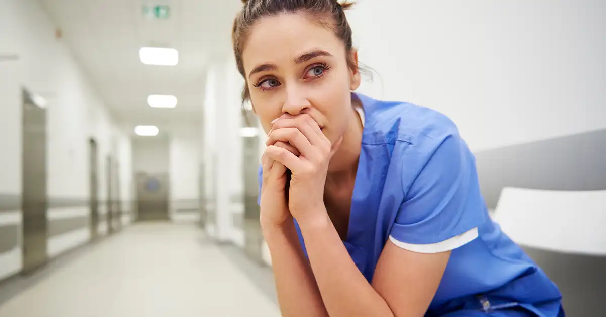 nurse-stressed Stressed out nurse who may potentially need a vaccine exemption lawyer for her clinical rotation