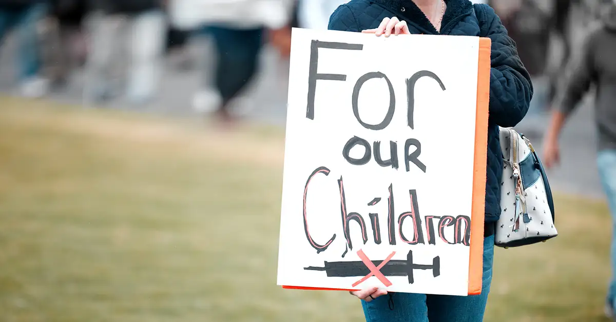 Person holding “For our Children” sign, legal help with vaccine exemption requests