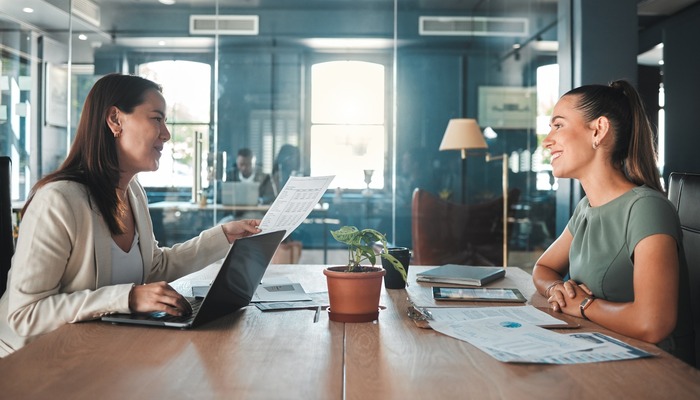 Two professionals reviewing paperwork in a modern office, representing consumer protection claims involving misleading emails and deceptive advertising.