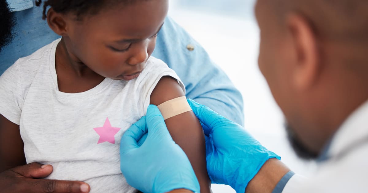 Child receiving a vaccination from a healthcare provider, illustrating the medical context surrounding potential vaccine injury claims