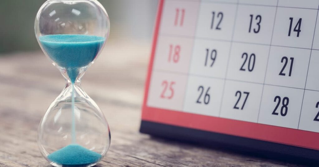 Hourglass beside a calendar, representing filing deadlines and time limits in vaccine injury cases