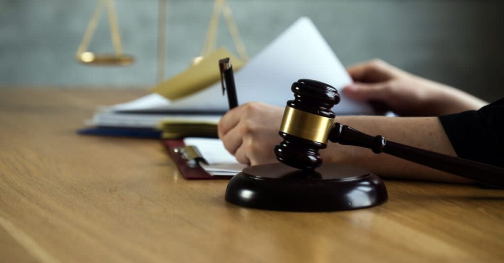 Judge’s gavel beside legal paperwork, symbolizing the formal legal process involved in vaccine injury claims
