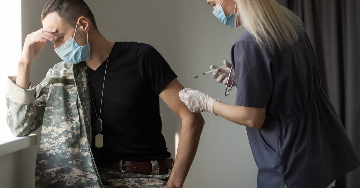 Service member contemplating receiving injection from nurse, thinking about vaccine exemption lawyer help.
