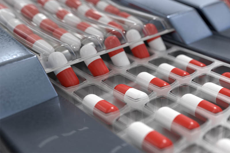 capsule pills being manufactured representing pharmaceutical fraud