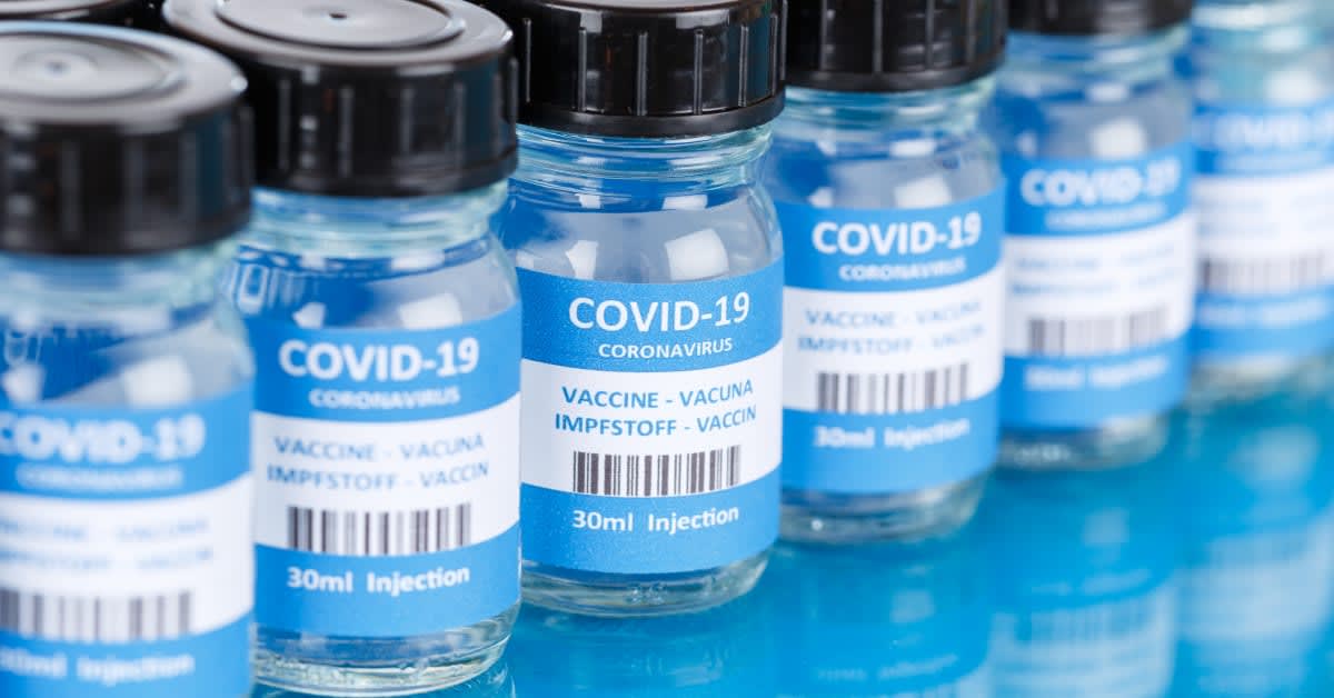 Close-up of COVID-19 vaccine vials, representing vaccination-related immigration requirements addressed by immigration attorneys.