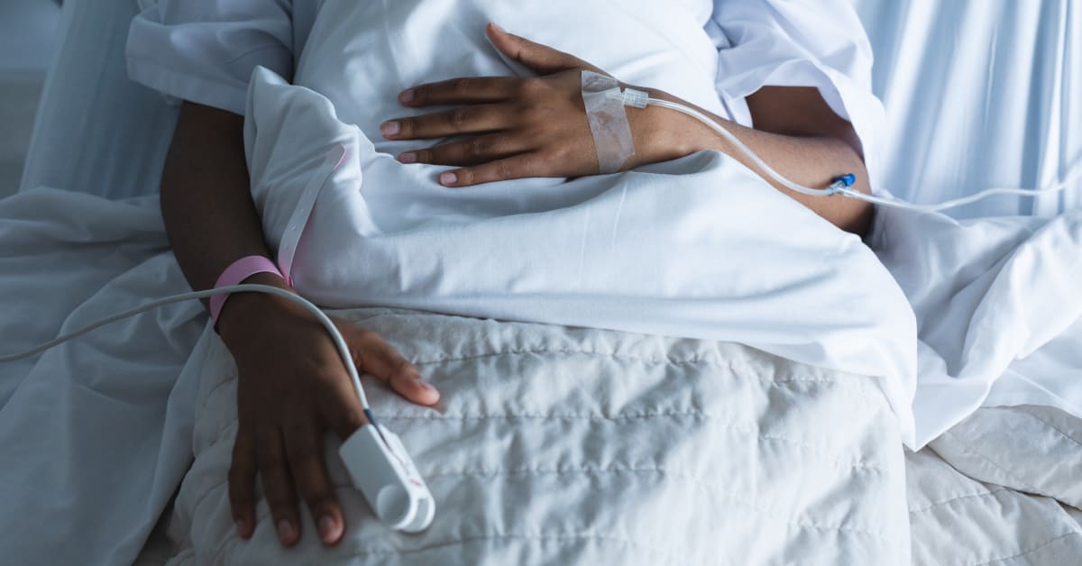 Patient resting in a hospital bed with medical monitoring equipment, reflecting serious complications associated with vaccine injuries