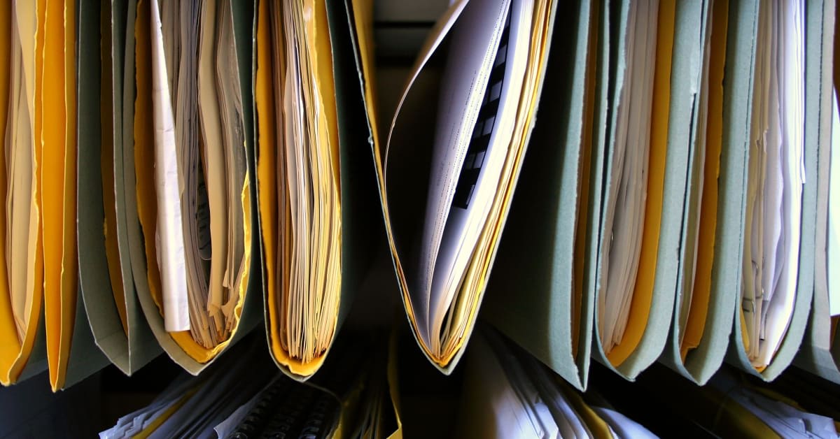 Close-up of paper files and folders, representing immigration records and documentation managed by immigration attorneys.