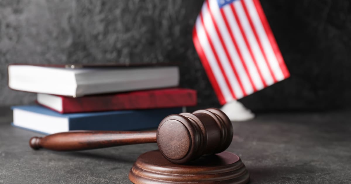 Gavel, law books, and a U.S. flag, representing immigration law matters handled by immigration attorneys.
