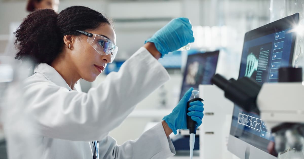 A scientist working in a laboratory, representing priority worker and employment-based immigration matters assisted by immigration attorneys.