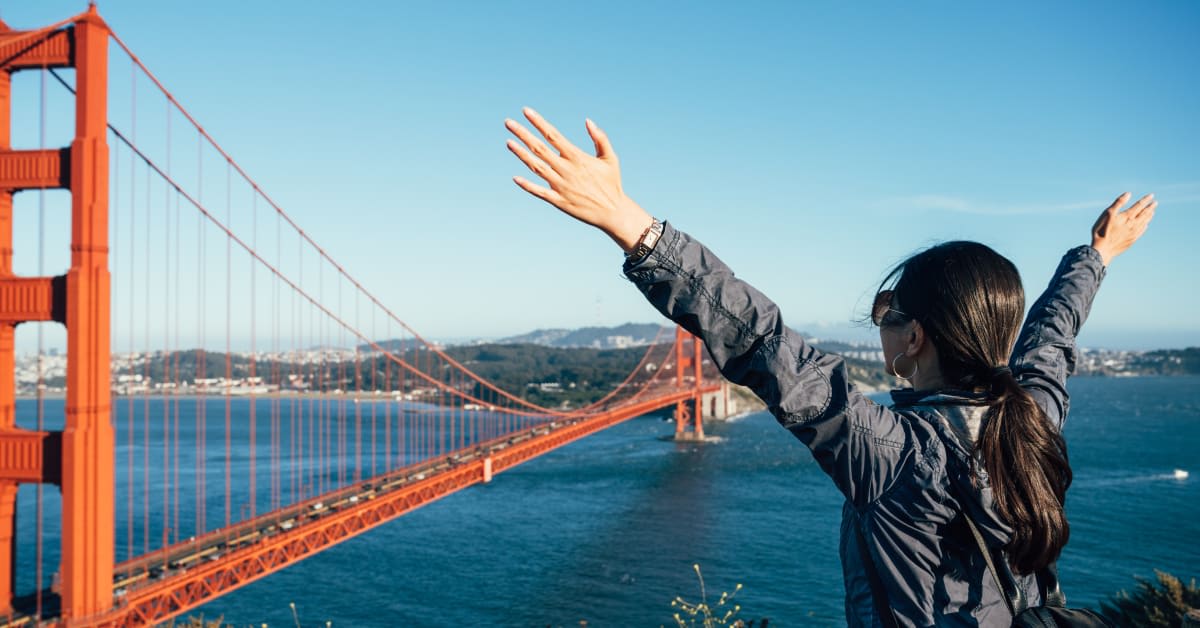A traveler overlooking the Golden Gate Bridge, representing tourism and visitor visa matters assisted by immigration attorneys.