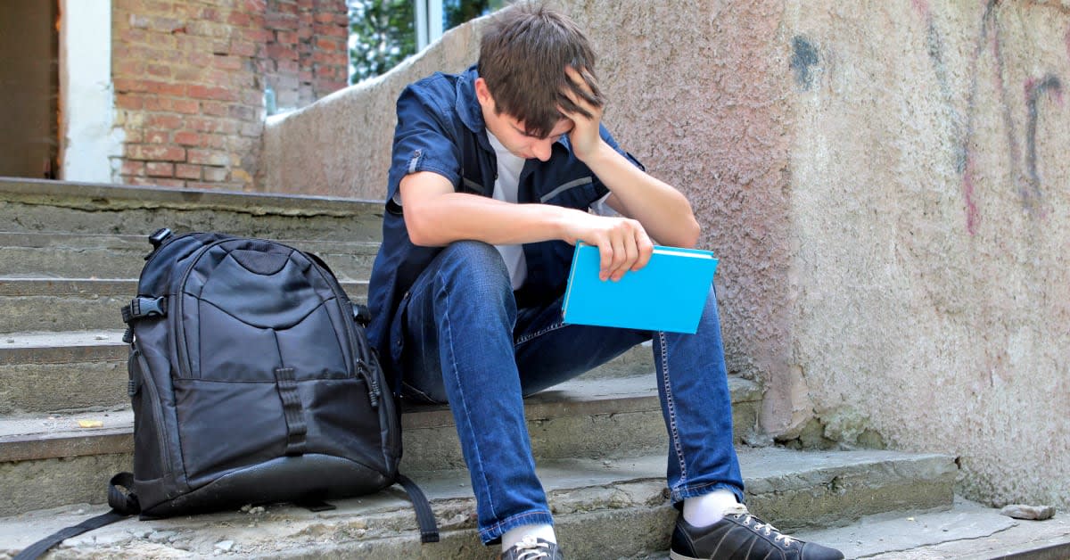 expelled-from-college-for-no-vaccine Distressed college student with backpack and notebook, student vaccine exemption legal help