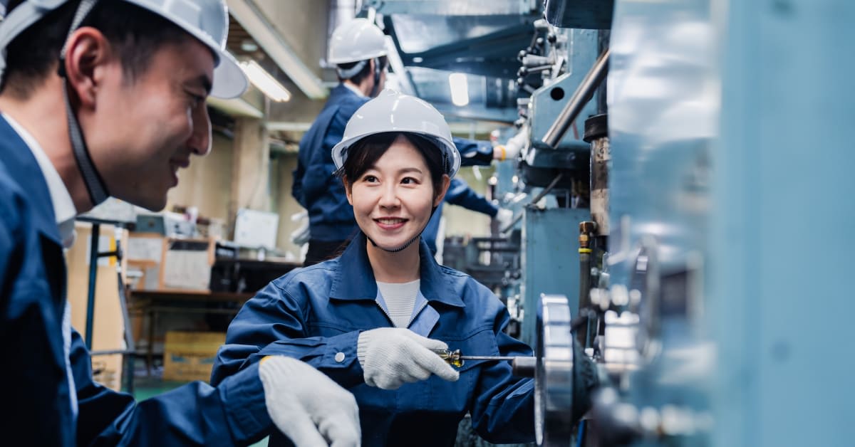 A skilled worker using machinery in an industrial setting, reflecting employment-based immigration matters handled by immigration attorneys.