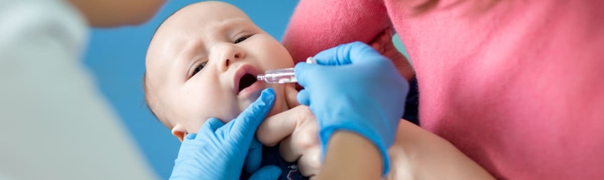 Infant being administered the rotavirus vaccine orally