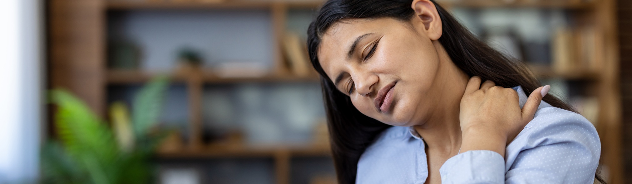 Woman experiencing neck and shoulder pain following a potential vaccine-related injury